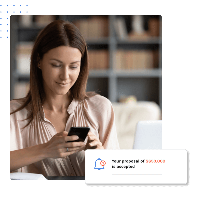 A woman focused on her phone, checking her email with a thoughtful expression in a well-lit environment.